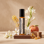 Good Girl Gone Bad perfume oil surrounded by white florals, peach, amber and cedar